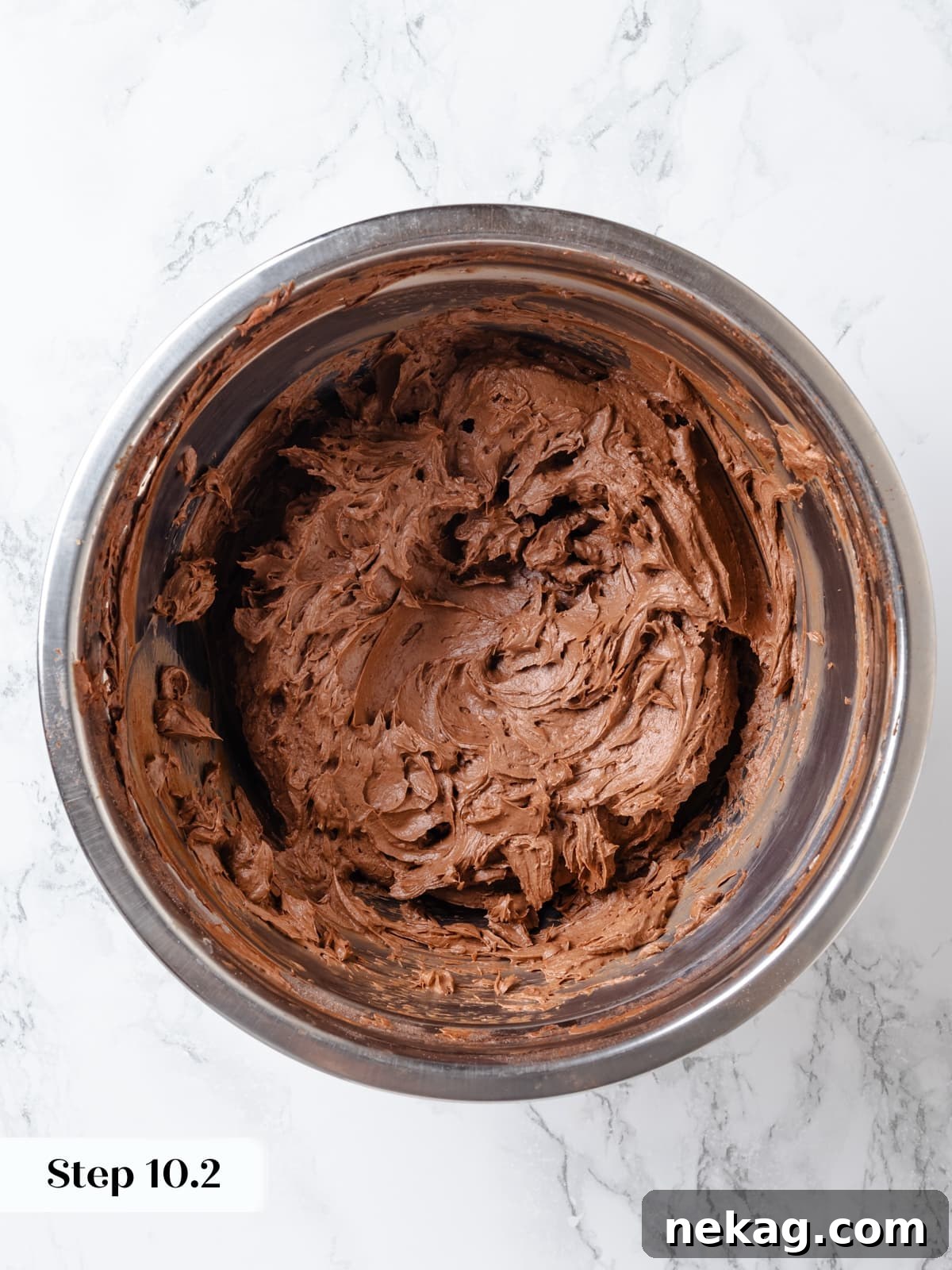 Chocolate cream cheese frosting mixed until perfectly smooth, creamy, and light in a mixing bowl.