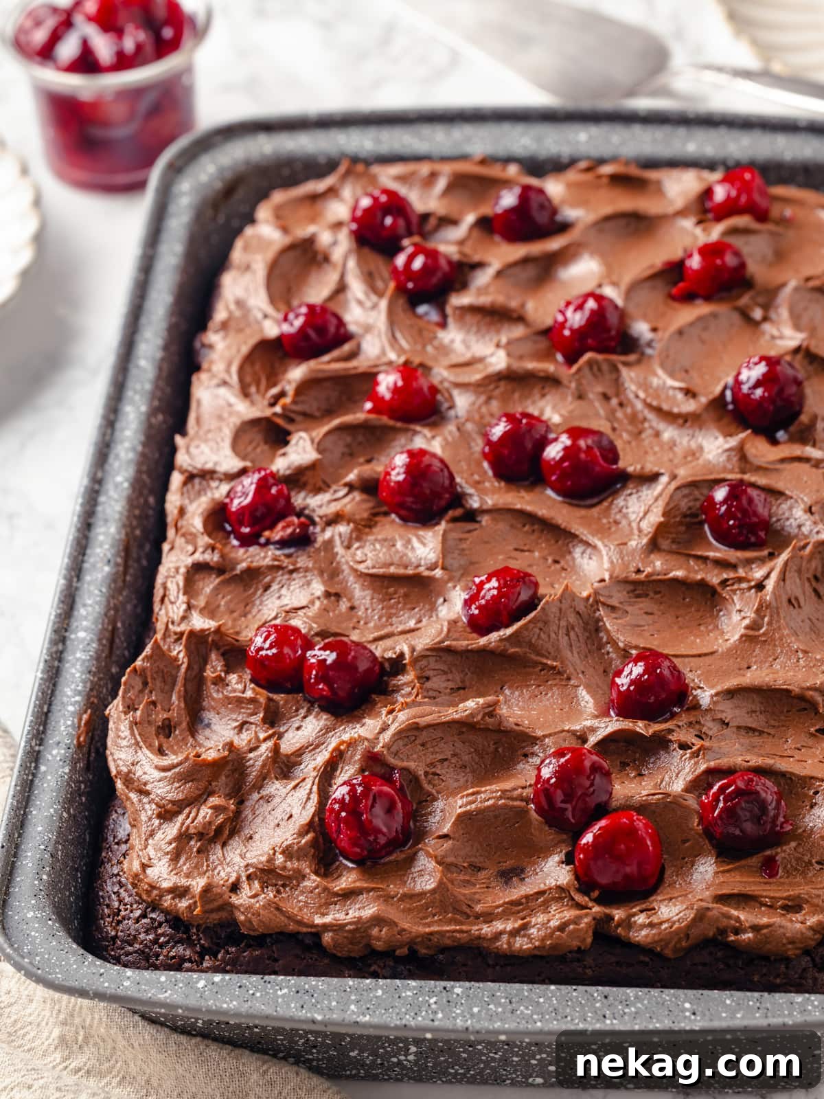 Luxurious chocolate cherry cake topped with generous cherry pie filling and soft swirled chocolate cream cheese frosting.