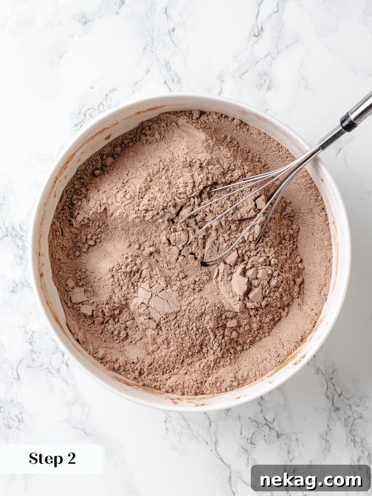 Dry ingredients combined evenly before adding to wet mixture in a mixing bowl.