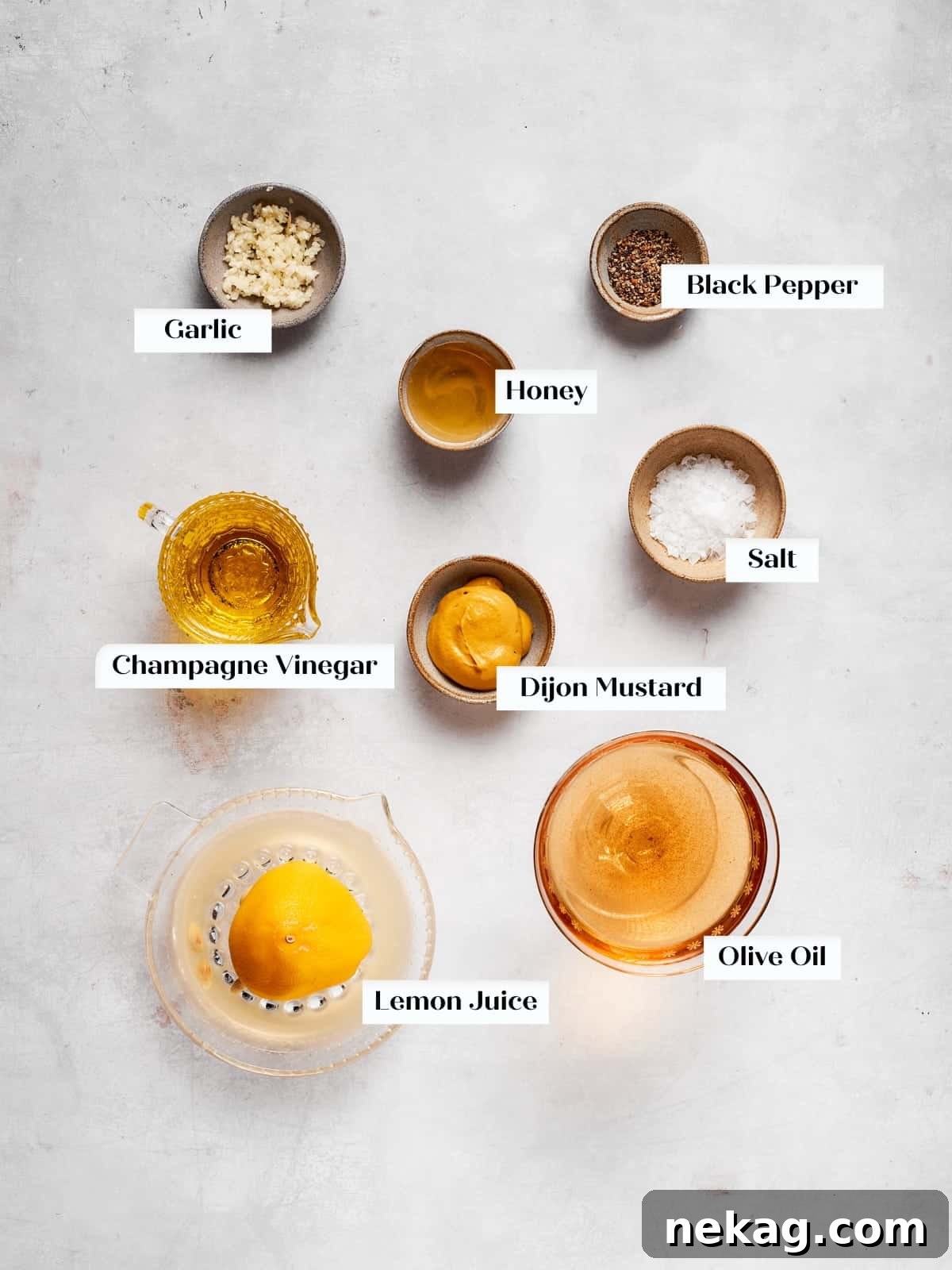 Simple, fresh ingredients meticulously laid out for making homemade champagne vinaigrette.