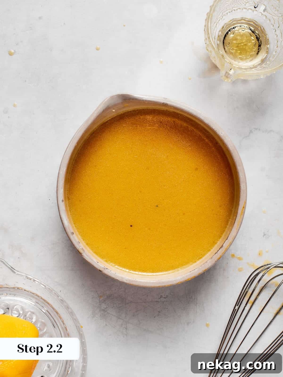 Smooth, beautifully emulsified champagne vinaigrette demonstrating a unified texture after whisking.