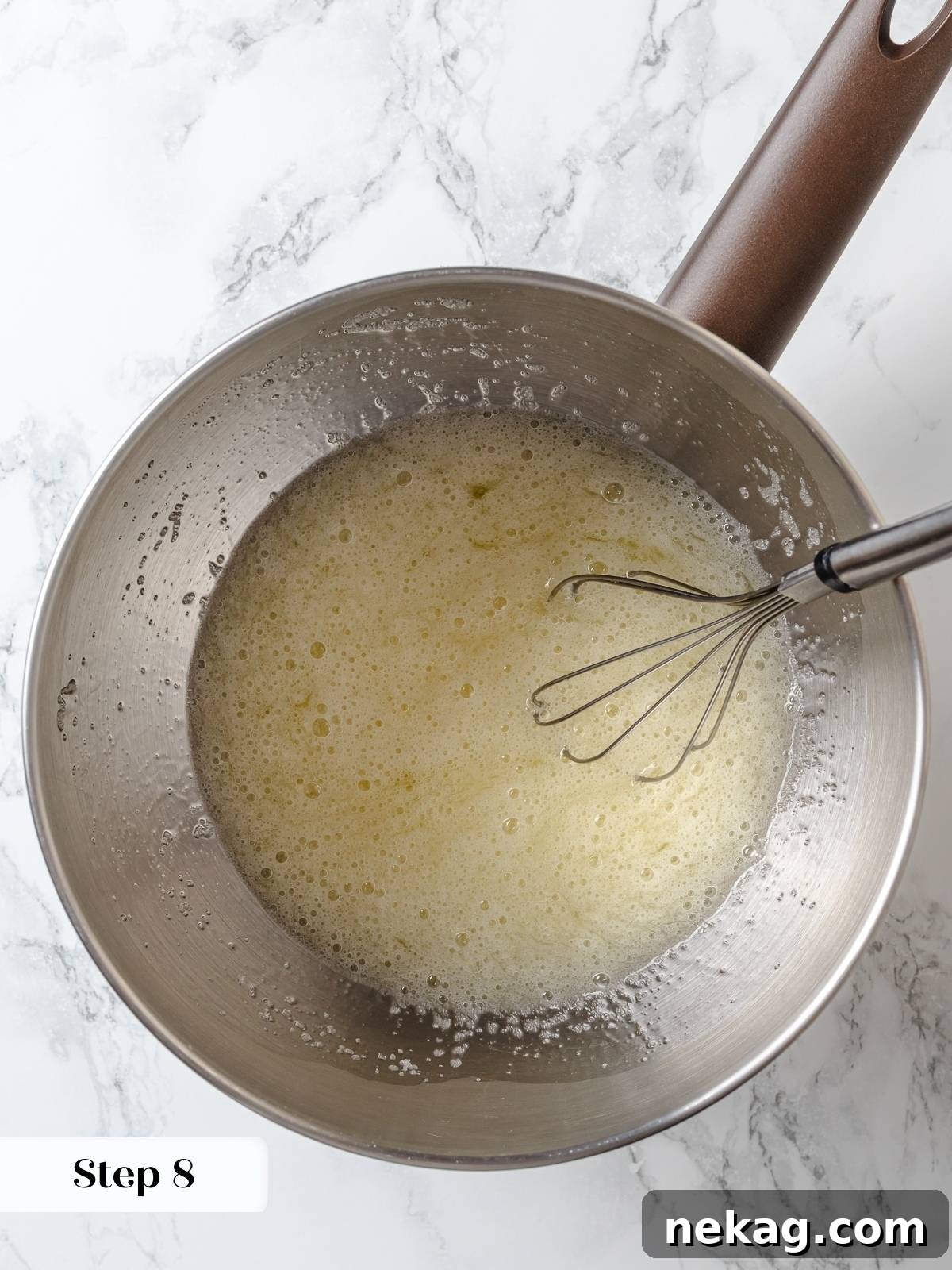 Zesty Lemon Delight Cake 16 Whisking egg whites and sugar over warm water until smooth and foamy.
