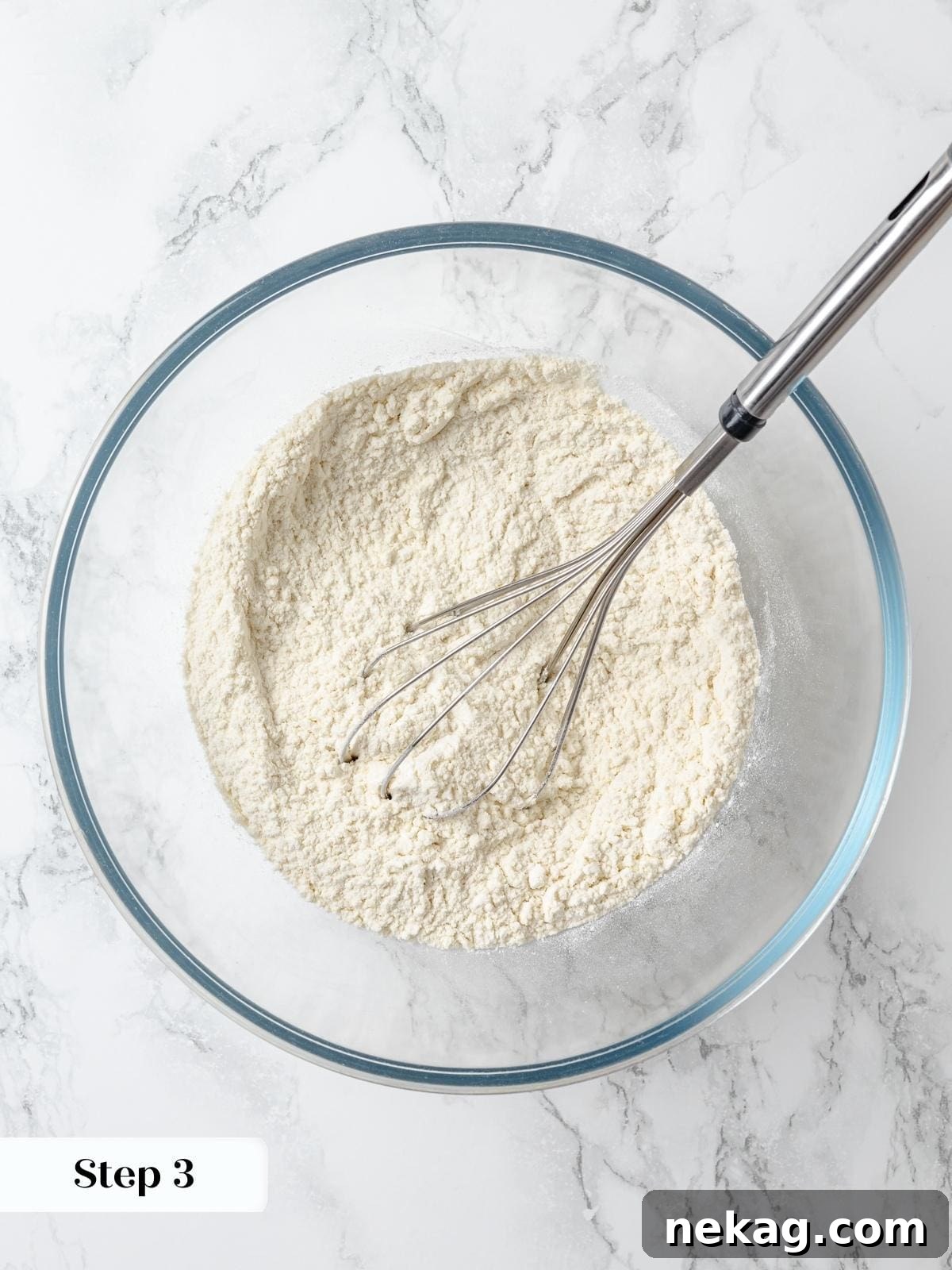 Zesty Lemon Delight Cake 7 Whisk combining cake flour, baking powder, and salt for lemon cake batter.
