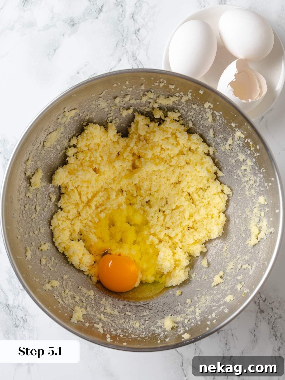 Zesty Lemon Delight Cake 9 Eggs added one at a time to lemon cake batter for proper emulsification.