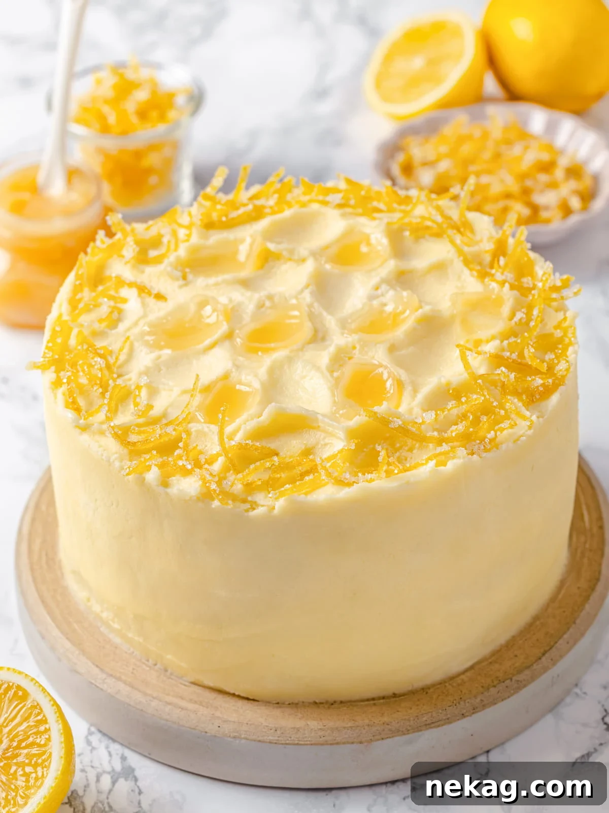 Silken Lemon Meringue Frosting 2 Fully frosted lemon cake finished with smooth, glossy lemon Swiss meringue buttercream, garnished with delicate lemon zest.