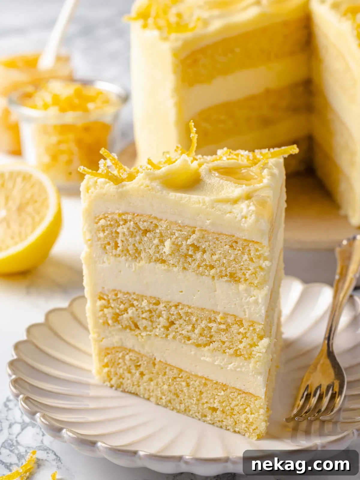 Silken Lemon Meringue Frosting 13 A beautiful slice of layered lemon cake showcasing generous, thick layers of silky lemon Swiss meringue buttercream.