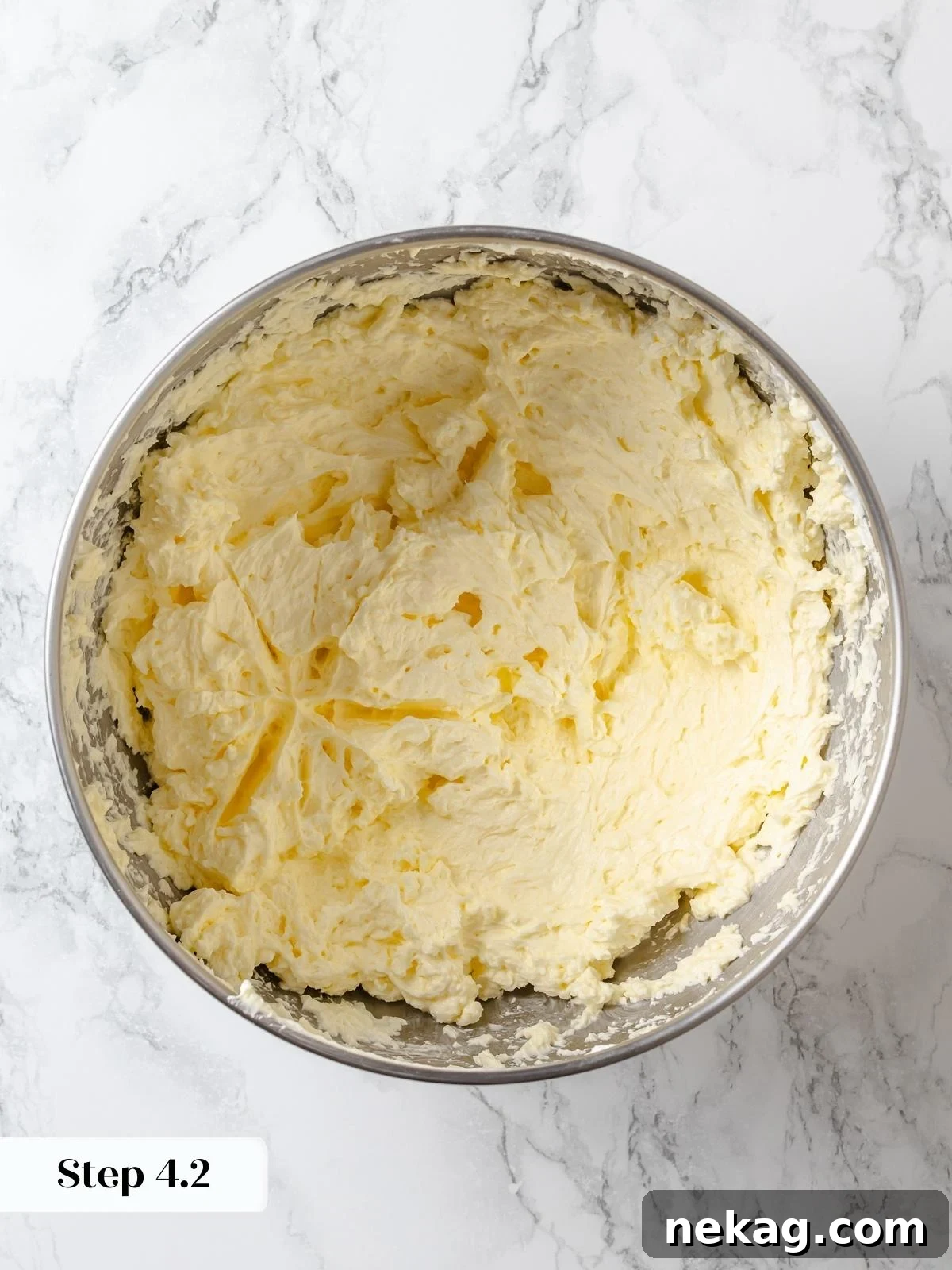 Silken Lemon Meringue Frosting 10 Butter mixed into Swiss meringue, gradually transforming into a cohesive, smooth buttercream texture.