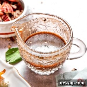 Lemon balsamic vinaigrette served in clear glass pitcher.