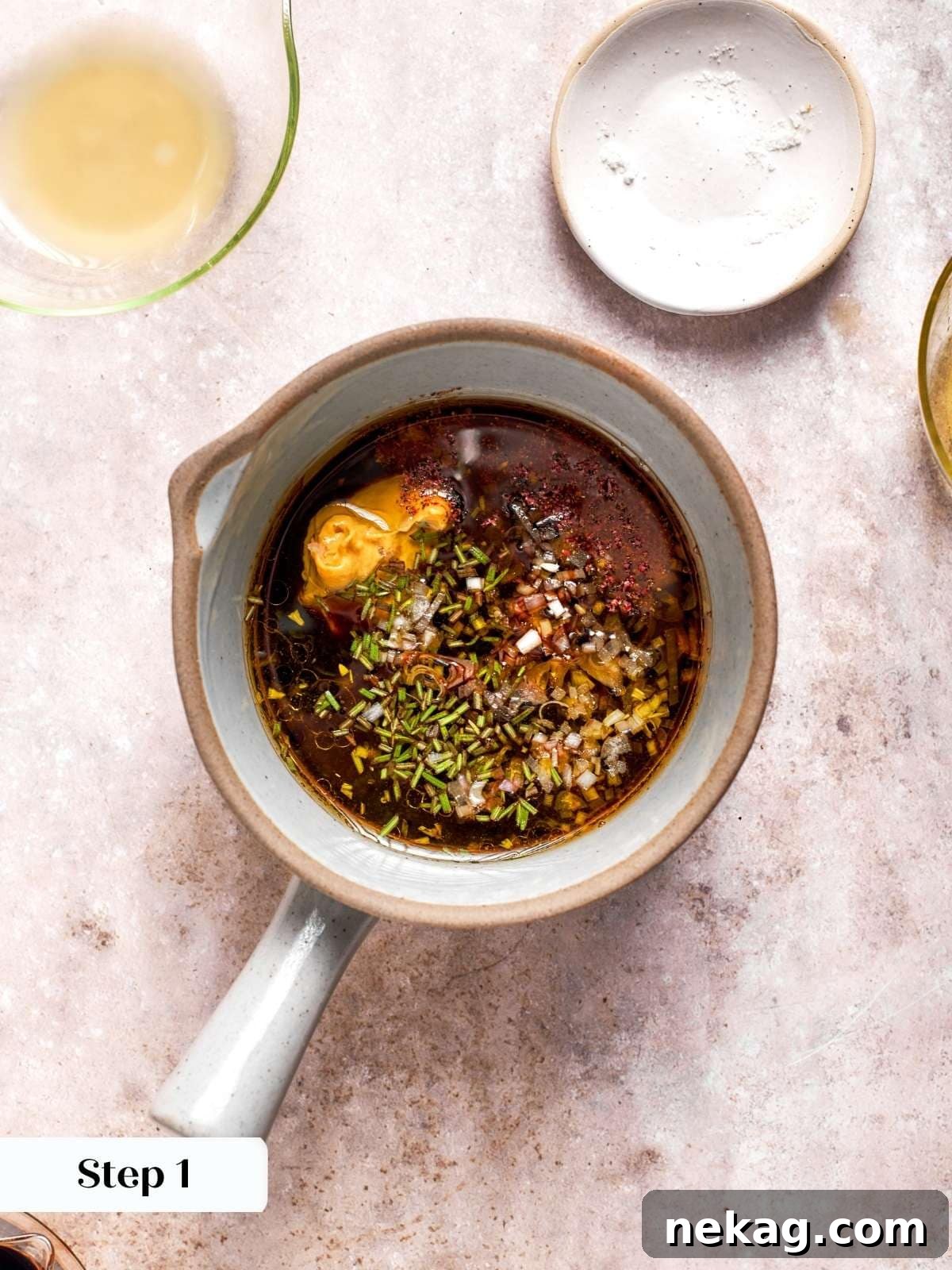 Measured balsamic, lemon juice, Dijon, and shallot in measuring cup.