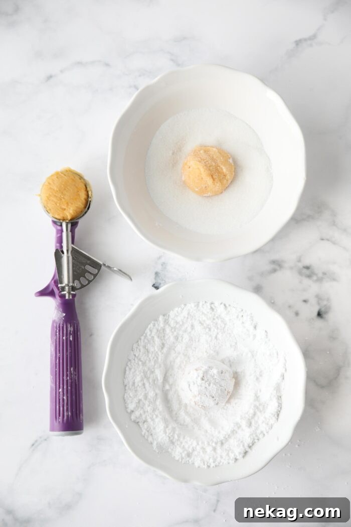Double coating orange cookie dough with sugar and powdered sugar.