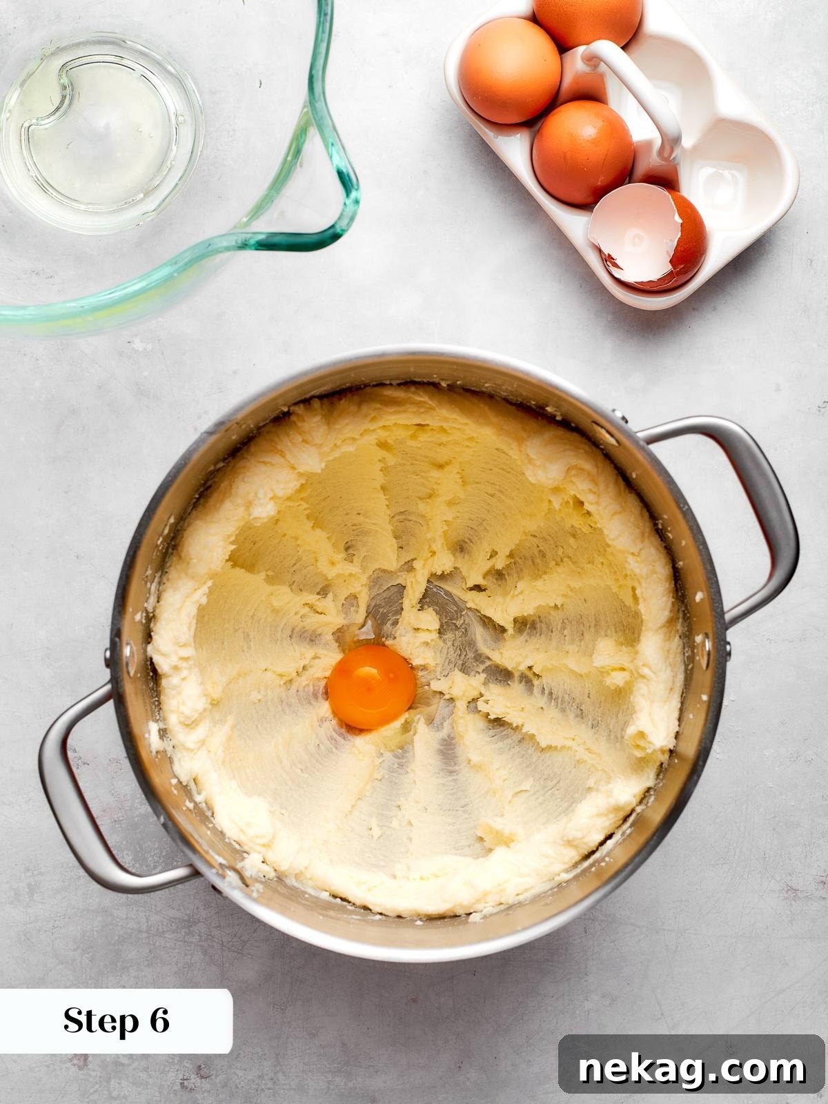 Egg yolk added to creamed butter and sugar mixture for cake batter.