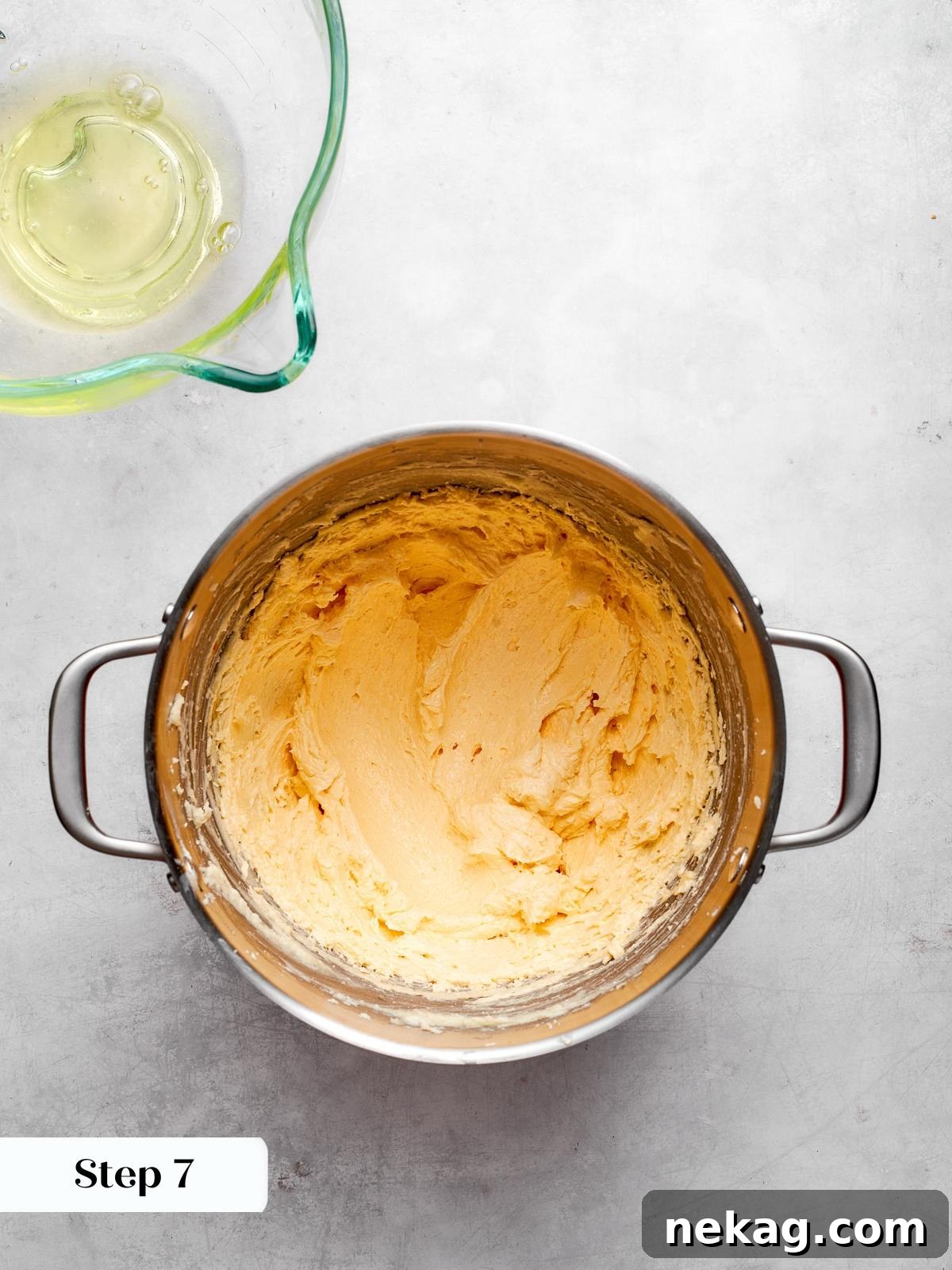 Pale cake batter prepared before melted chocolate is added to mixture.