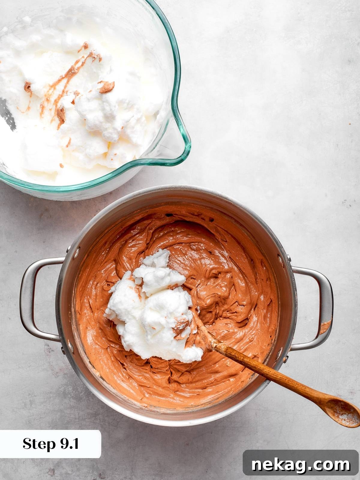 Spoon folding stiff egg whites into cake batter to keep mixture airy.