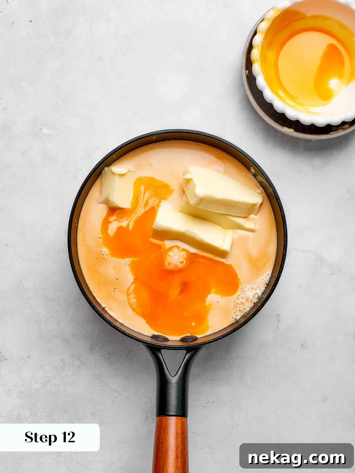 Custard base simmering with evaporated milk, butter, sugar, and egg yolks.