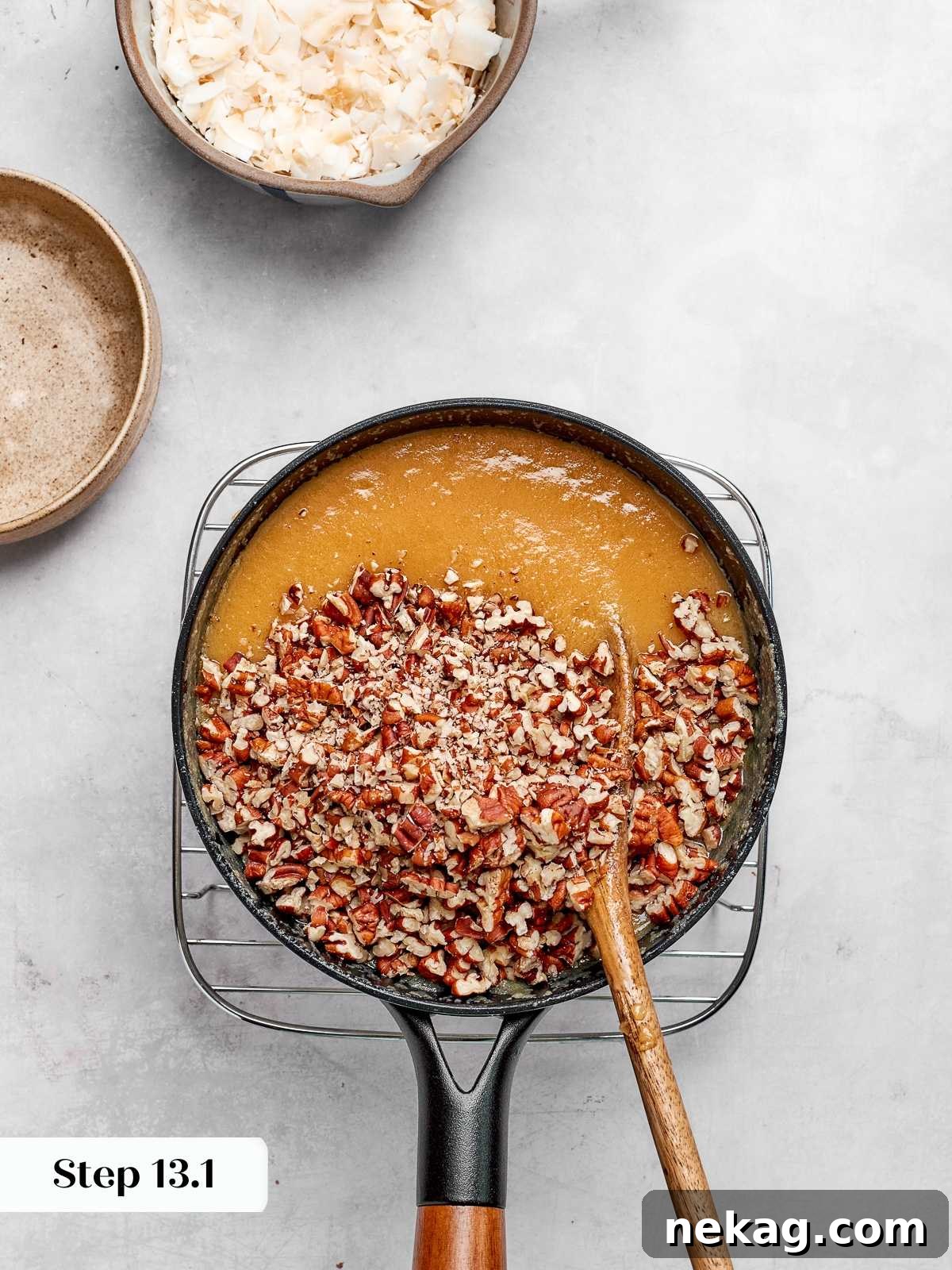 Toasted pecans folded into caramelized coconut frosting mixture.