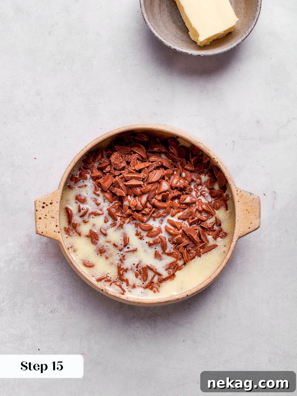 Cream warming in saucepan to prepare ganache filling.