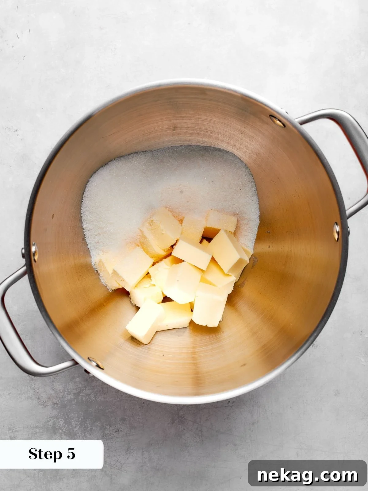 Creaming butter and sugar to create airy structure for chocolate cake batter.