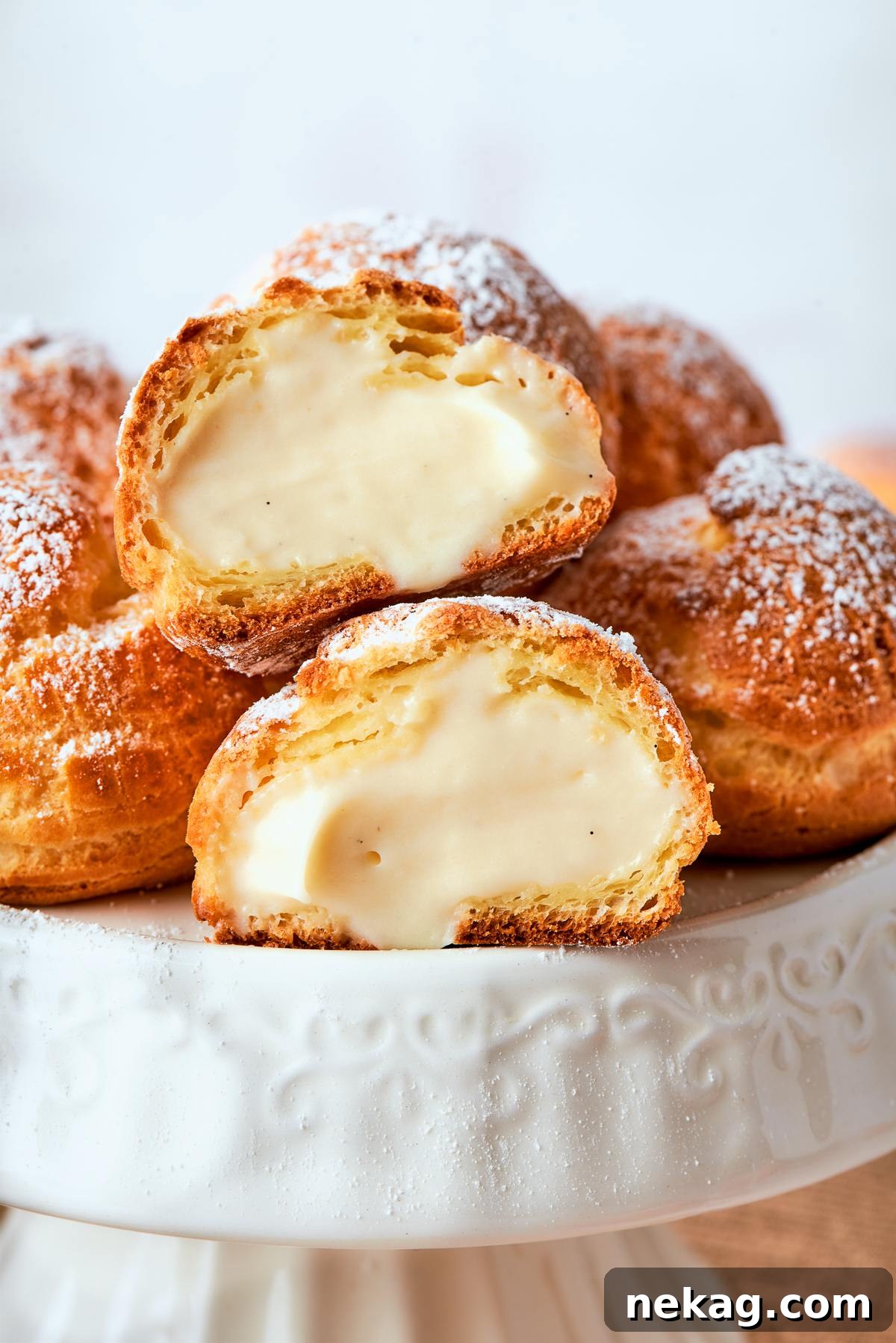 Sweet Puffs of Delight 35 Filled cream puffs displayed on cake stand with light dusting of powdered sugar.