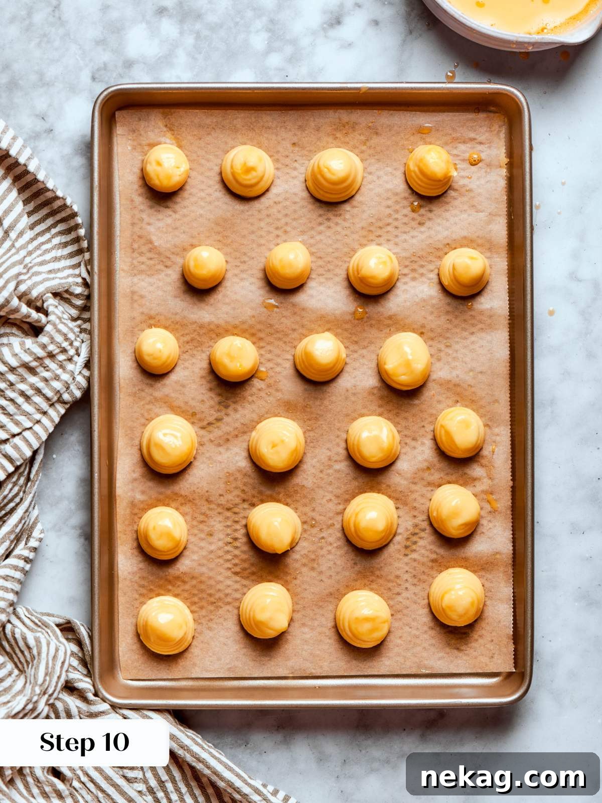 piped choux pastry rounds egg washed.