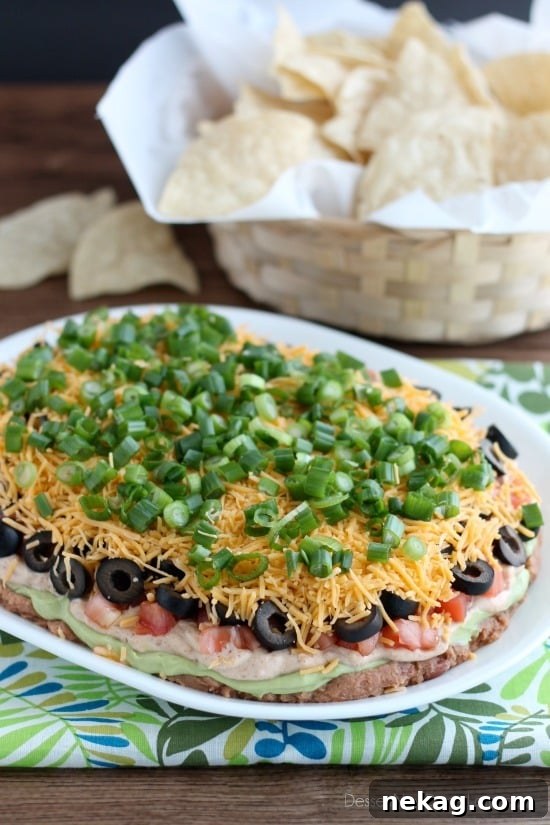 Classic Seven-Layer Dip Recipe for Parties and Game Day 2 Seven Layer Dip is a classic party snack or football food. This version has a secret ingredient to make it a dip that is sure to get gobbled up by your guests!