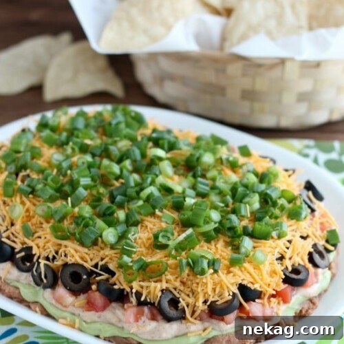 Classic Seven-Layer Dip Recipe for Parties and Game Day 6 Seven Layer Dip is a classic party snack or football food. This version has a secret ingredient to make it a dip that is sure to get gobbled up by your guests!