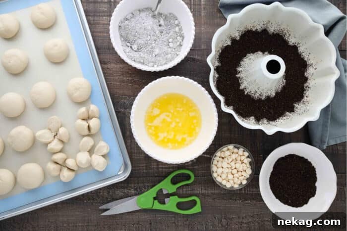 Ingredients for Oreo Monkey Bread: Rhodes rolls, crushed Oreo chocolate sandwich cookies, Oreo pudding mix, melted butter, white chocolate chips.