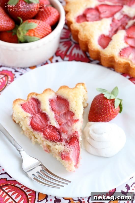 This Strawberry Cake is lightly sweet, layered with fresh sliced strawberries, and is served with a side of coconut whipped cream. A stunning and delicious dessert for any occasion or Valentine's Day.