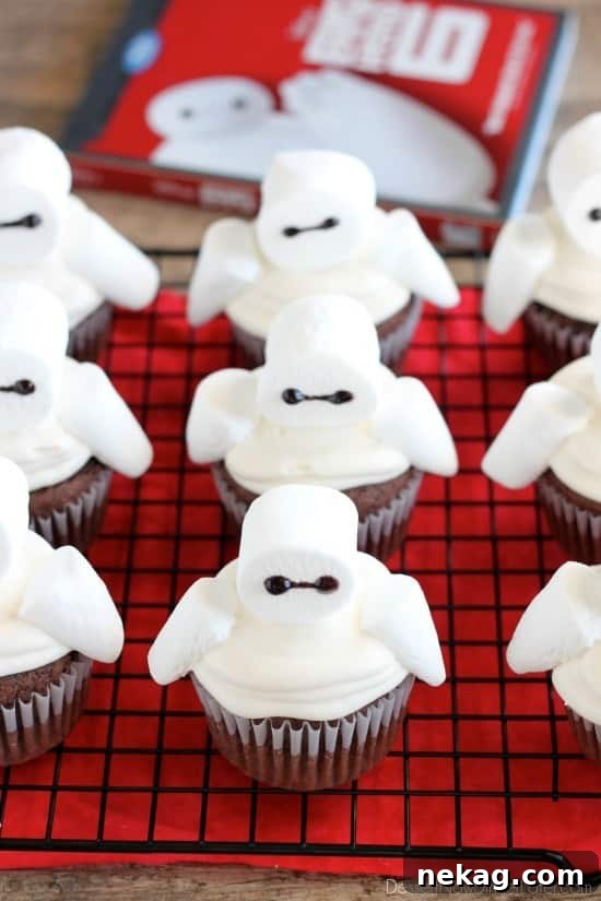 Baymax Cupcakes: Big Hero 6-Themed Treats for Parties 6 Big Hero 6 comes to life at home with these Baymax Cupcakes topped with marshmallow frosting and large marshmallows. {Step-by-Step Tutorial}