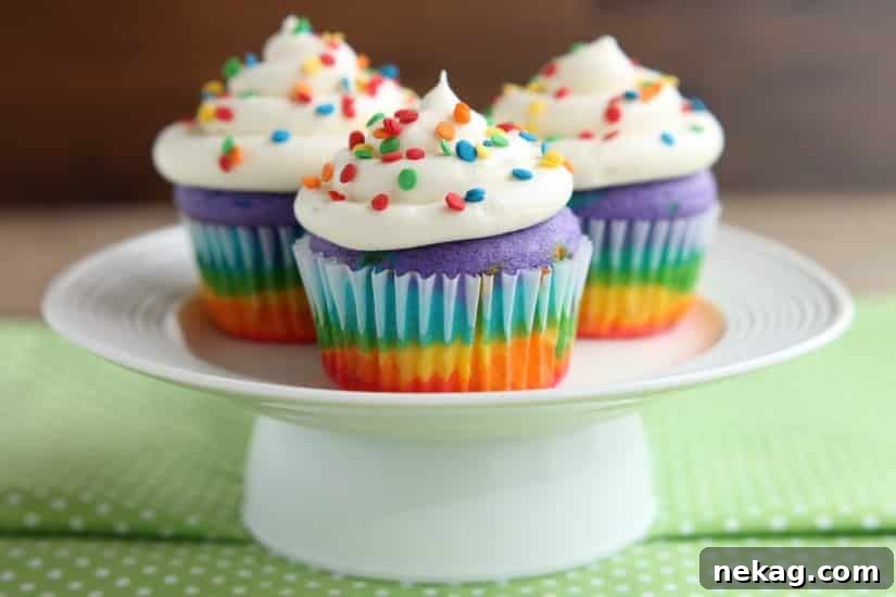 How to Make Colorful Rainbow Cupcakes (With Video Tutorial) 10 Baked rainbow cupcakes ready to frost