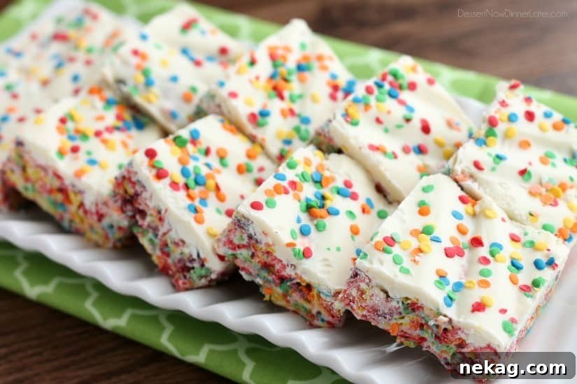 Fruity Pebbles, marshmallows, white chocolate, and confetti sprinkles, come together to make these Rainbow Krispie Treats! An easy St. Patrick's Day dessert!