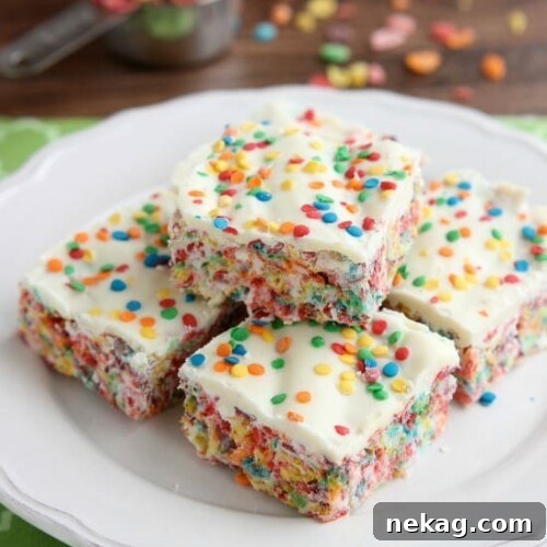 Fruity Pebbles, marshmallows, white chocolate, and confetti sprinkles, come together to make these Rainbow Krispie Treats! An easy St. Patrick's Day dessert!