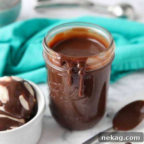 Hot fudge dripping down the side of a mason jar.