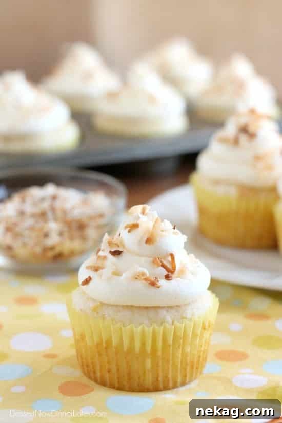 These Pina Colada Cupcakes have crushed pineapple in the cake, and coconut & rum extracts in the frosting, for a frozen drink inspired tropical dessert!