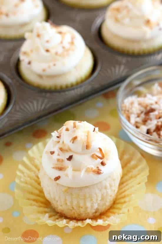 These Pina Colada Cupcakes have crushed pineapple in the cake, and coconut & rum extracts in the frosting, for a frozen drink inspired tropical dessert!