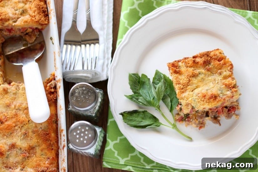 Savory Breakfast Bread Pudding has sausage, tomatoes, eggs, and herbs all in a cheesy bread pudding.