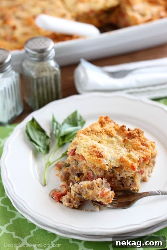 Savory Breakfast Bread Pudding has sausage, tomatoes, eggs, and herbs all in a cheesy bread pudding.