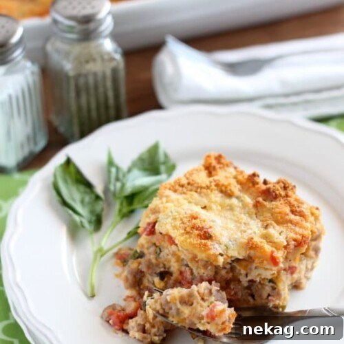 Savory Breakfast Bread Pudding has sausage, tomatoes, eggs, and herbs all in a cheesy bread pudding.