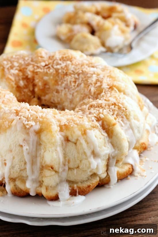 Pina Colada Monkey Bread - toasted coconut, crushed pineapple, and a secret ingredient combine together to make this sticky pull apart bread a tropical treat!