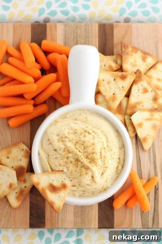This Easy Garlic Hummus blends up in less than 1 minute for a smooth and creamy homemade hummus that goes perfectly with vegetables and crackers!