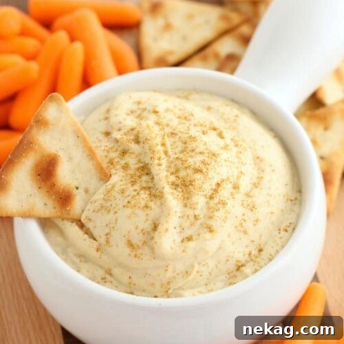 This Easy Garlic Hummus blends up in less than 1 minute for a smooth and creamy homemade hummus that goes perfectly with vegetables and crackers!