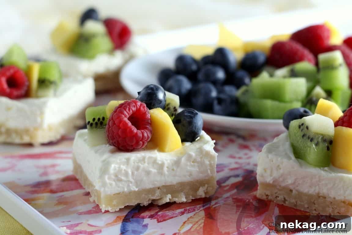 Close-up of Fruit Cheesecake Bars topped with fresh fruit