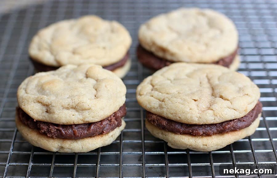 Chewy Peanut Butter Cookies are sandwiched between a simple Fudge Frosting to create an ultimate peanut butter chocolate cookie worth devouring!