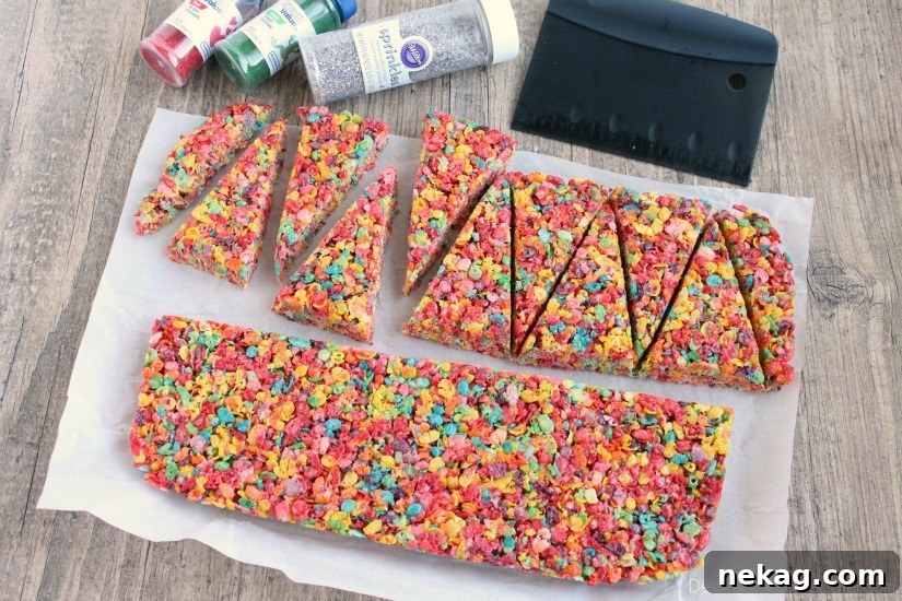 Krispie Treat Christmas Tree Recipe for Festive Holiday Treats 4 Fruity Pebbles cereal lights up these festive Krispie Treat Christmas Trees that are easy and fun to make for the holidays!