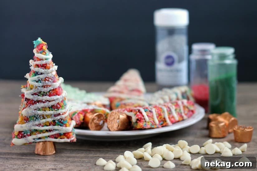 Krispie Treat Christmas Tree Recipe for Festive Holiday Treats 8 Fruity Pebbles cereal lights up these festive Krispie Treat Christmas Trees that are easy and fun to make for the holidays!