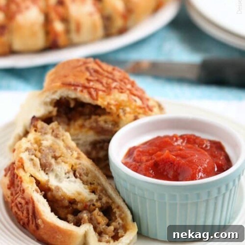This Sausage Stromboli is a delicious hot sandwich that feeds a crowd! Make it for dinner or as an appetizer served with marinara for the big football game!