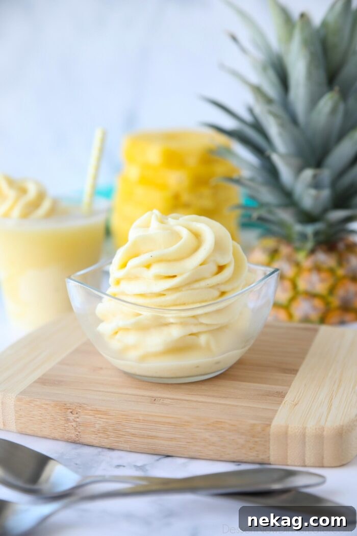 Creamy Pineapple Whip Recipe — Homemade Tropical Dessert 6 Dole Whip swirled in a small dish.