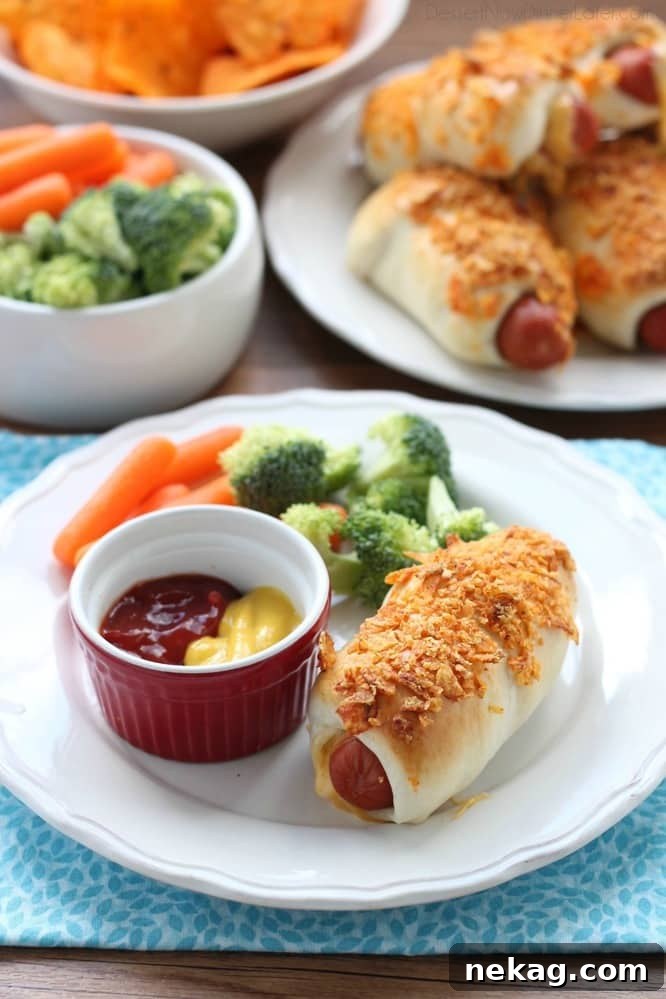 Frozen dough, nacho tortilla chips, and extra cheese transform ordinary pigs in a blanket into these extraordinary crunchy nacho dogs.
