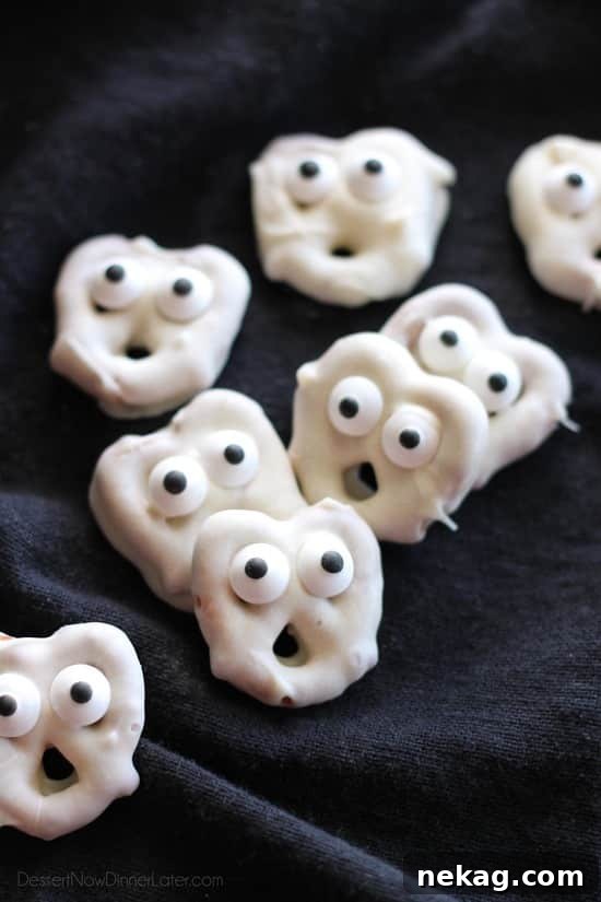 How to Make Spooky Ghost Pretzels (Video Tutorial) 2 Ghost Pretzels - White chocolate dipped pretzels are made into ghosts with candy eyes and a little bit of imagination.