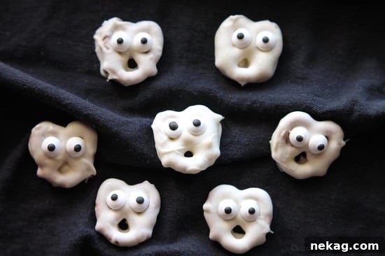 How to Make Spooky Ghost Pretzels (Video Tutorial) 3 Ghost Pretzels - White chocolate dipped pretzels are made into ghosts with candy eyes and a little bit of imagination.