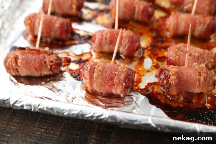 Close up of baked smokies with bacon and brown sugar just out of the oven.